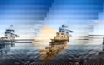 The Delfin III glides over glassy Amazon waters, offering luxury and adventure deep in the jungle. 