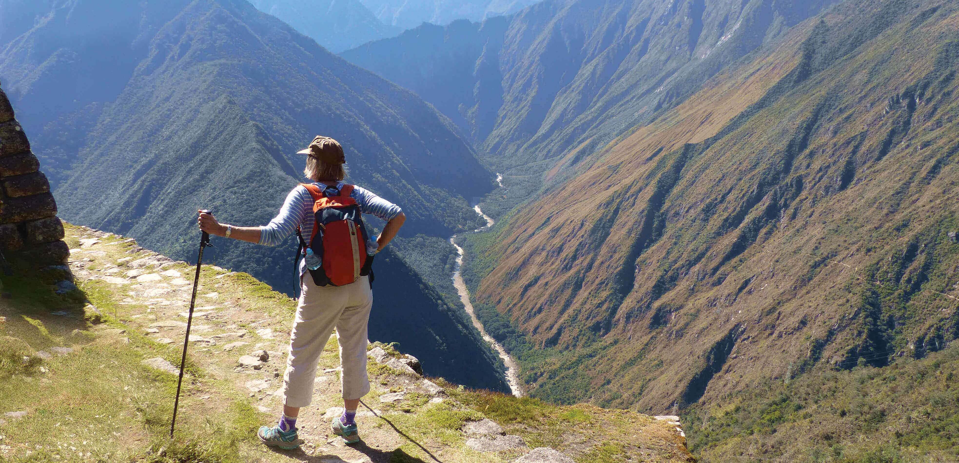 Hiker on the Inca overlooking Andes mountains near Machu Picchu, Peru adventure trek. 
