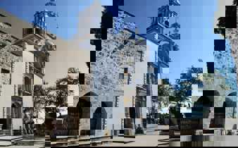 Elegant colonial church in Mexico with stone facade and baroque towers, standing beneath a clear blue sky. 