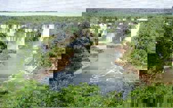 Iguassu Falls thunders through Brazil's rainforest in a sweeping panoramic view. 